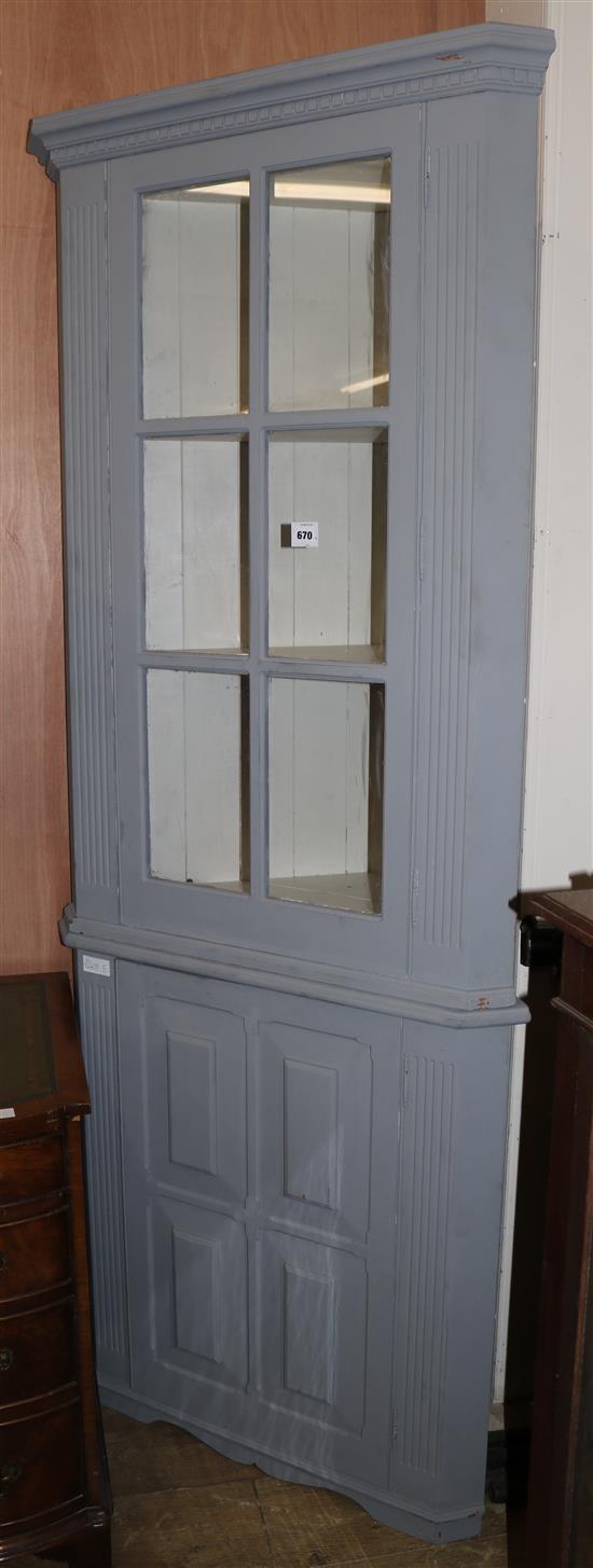 A grey blue painted standing display cabinet